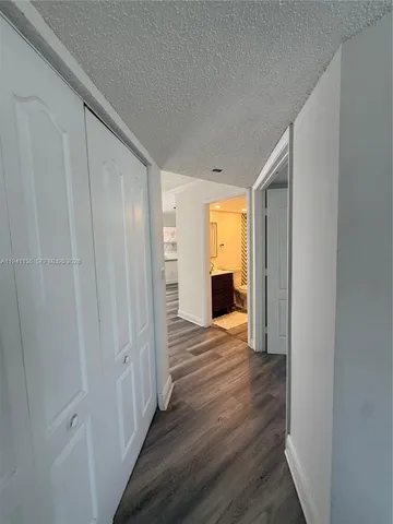 a view of empty room with wooden floor and cabinet