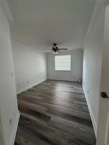 a view of wooden floor and window in a room