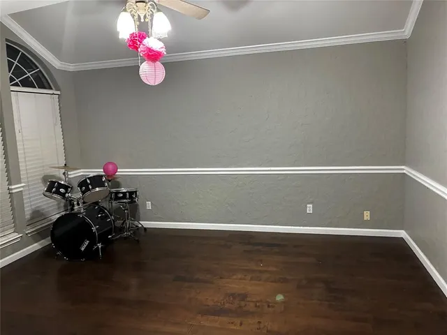 a view of a hardwood floor and a chandelier fan