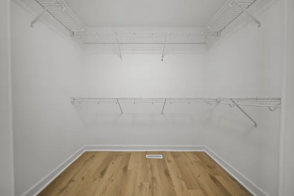 a spacious bathroom with a double vanity sink toilet and shower