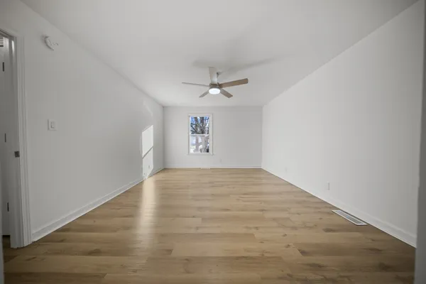 wooden floor in an empty room with a window