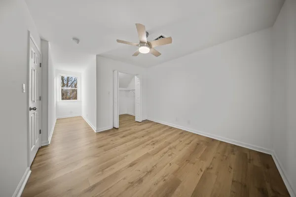 a view of an empty room with wooden floor