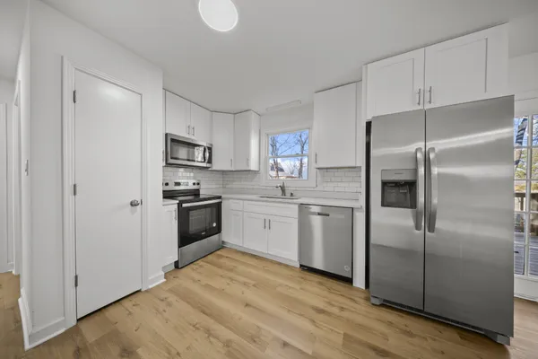 a kitchen with a refrigerator stove and a sink