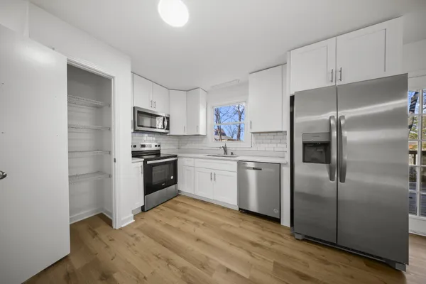 a kitchen with a refrigerator stove and microwave
