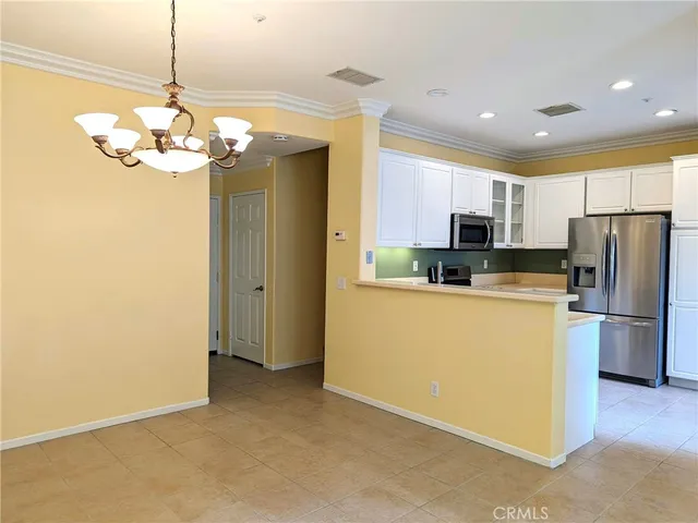 a kitchen with stainless steel appliances granite countertop cabinets a refrigerator and a stove top oven