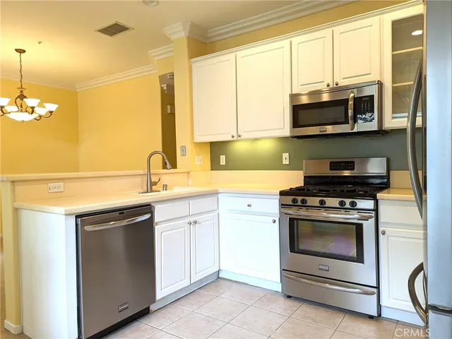 a kitchen with stainless steel appliances granite countertop a sink and a stove