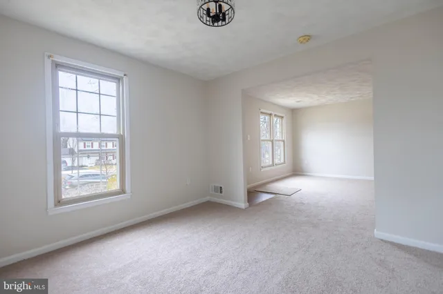an empty room with windows and closet