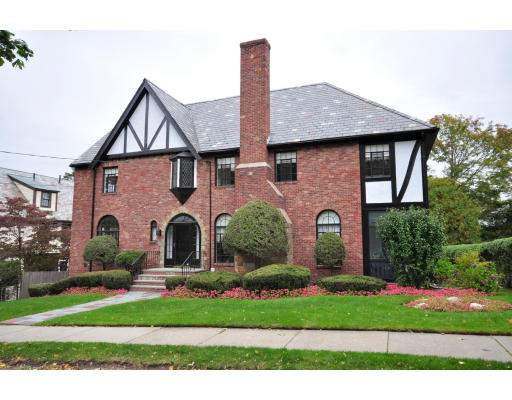 a front view of house with yard and green space