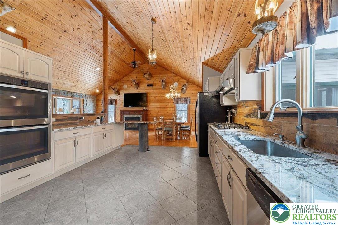 134 Split Rock Road Newfoundland, PA 18445 - Photo 28 of 84 a kitchen with stainless steel appliances granite countertop a sink and cabinets
