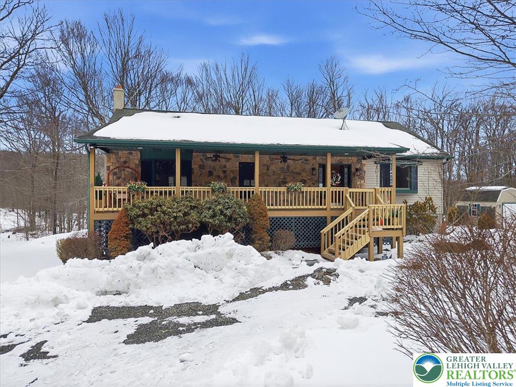 134 Split Rock Road Newfoundland, PA 18445 - Photo 3 of 84 a view of a patio with a table and chairs under an umbrella