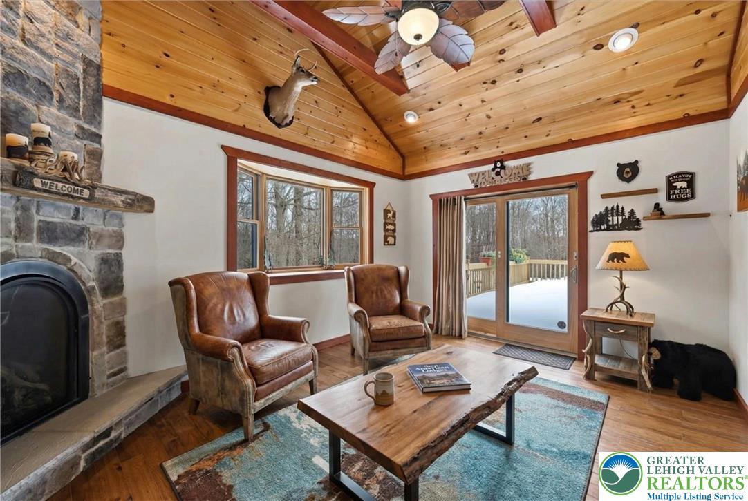 134 Split Rock Road Newfoundland, PA 18445 - Photo 35 of 84 a living room with furniture a fireplace and a table