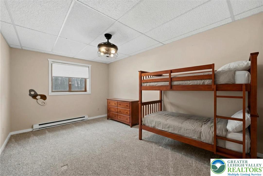 134 Split Rock Road Newfoundland, PA 18445 - Photo 50 of 84 a bedroom with a bed and a chandelier