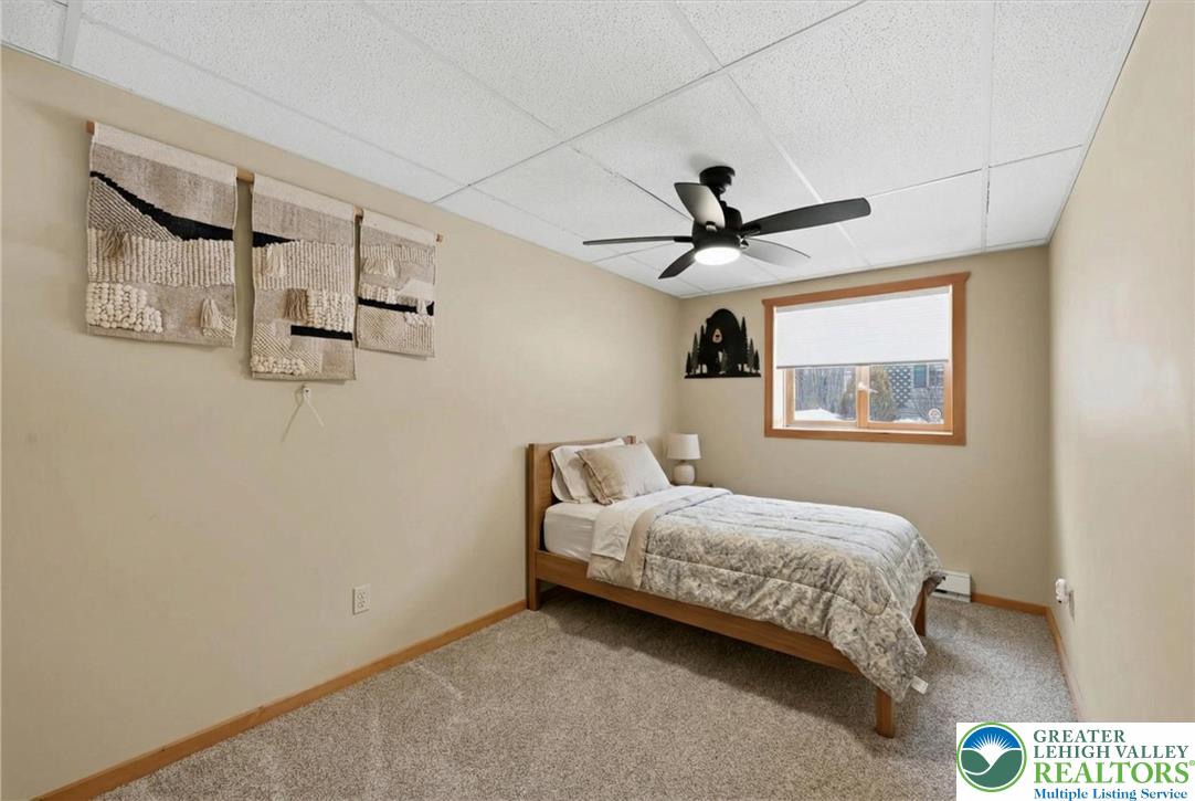 134 Split Rock Road Newfoundland, PA 18445 - Photo 55 of 84 a bedroom with a bed and a ceiling fan