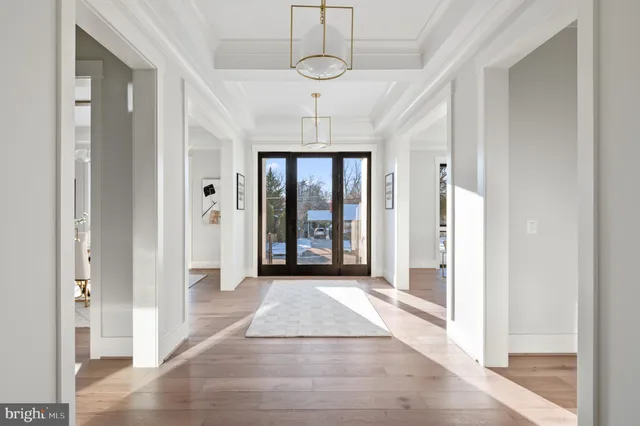 a view of a hallway with wooden floor and windows
