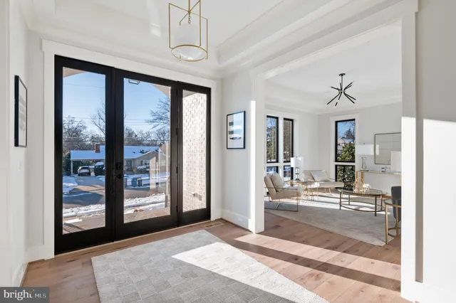 a living room with hardwood floor and a ceiling fan