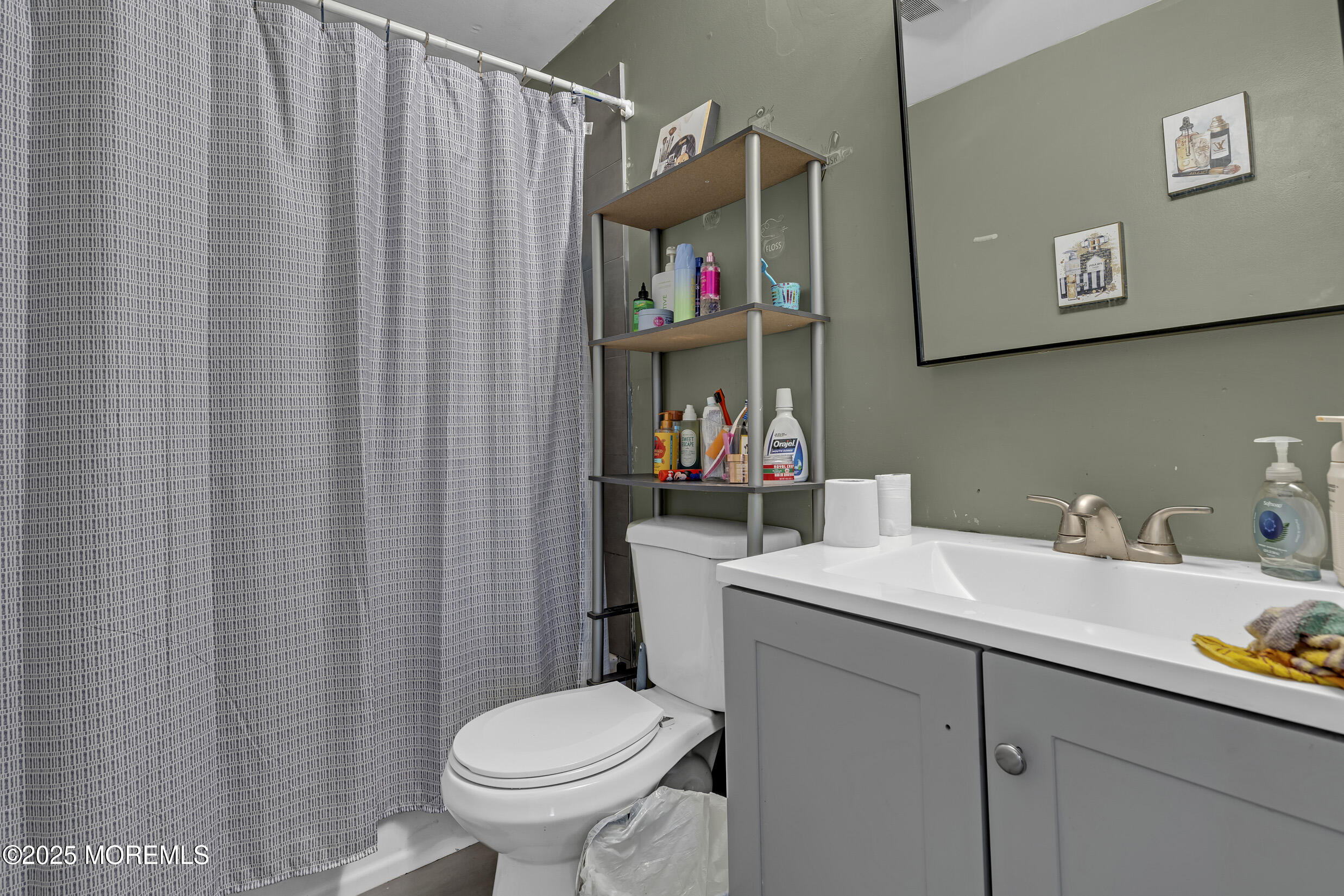320 Pennsylvania Avenue Pine Beach, NJ 08741 - Photo 16 of 29 a bathroom with a sink a toilet and a mirror
