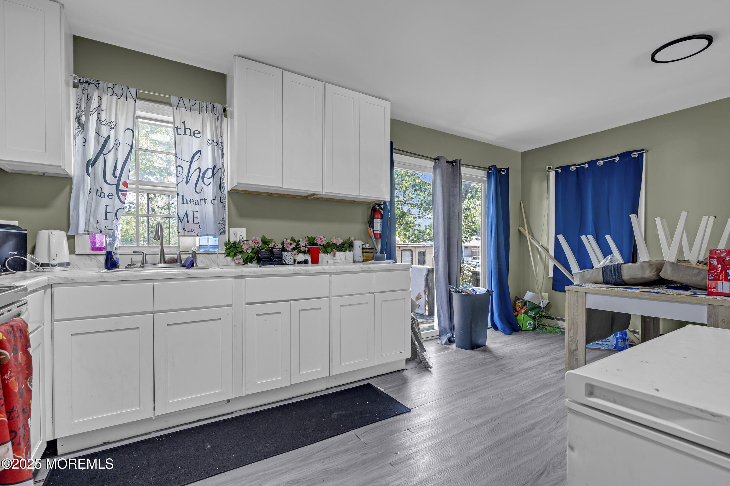 320 Pennsylvania Avenue Pine Beach, NJ 08741 - Photo 7 of 29 a kitchen with a refrigerator and white cabinets
