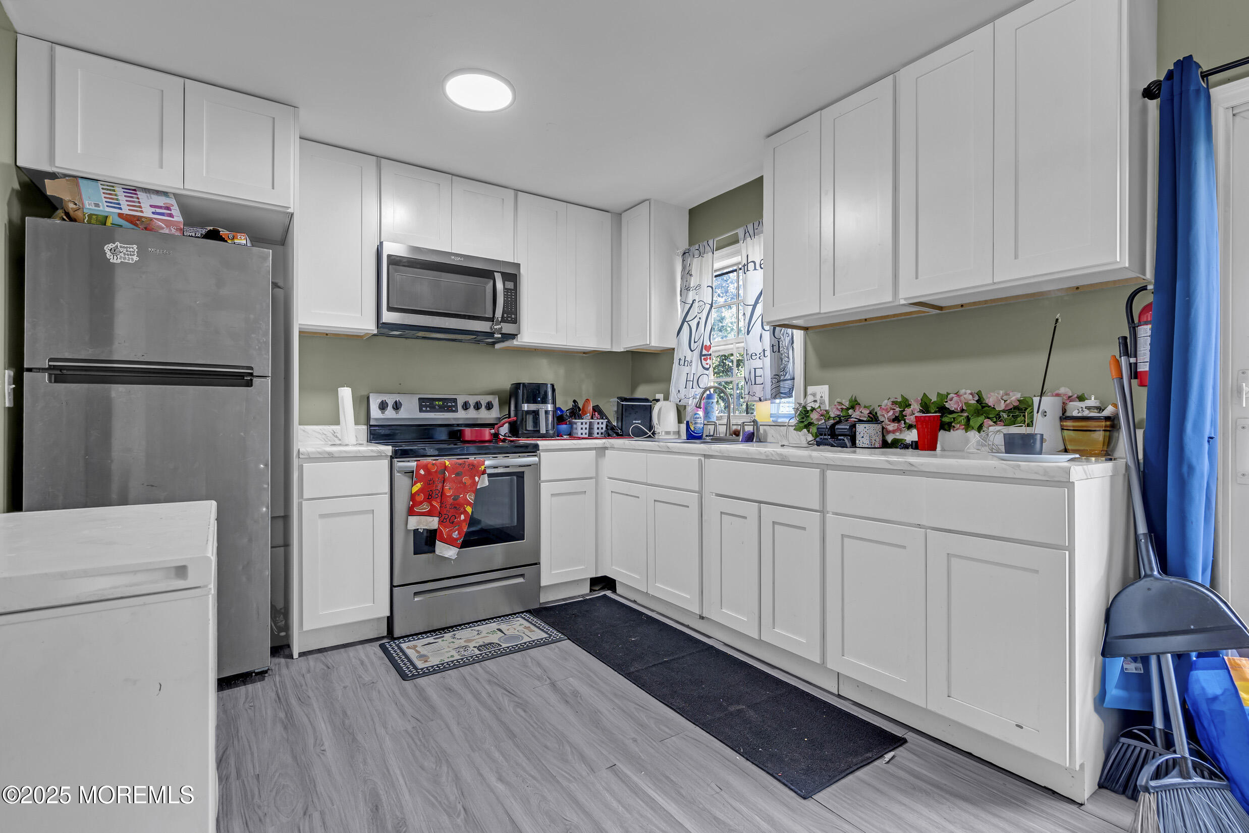 320 Pennsylvania Avenue Pine Beach, NJ 08741 - Photo 8 of 29 a kitchen with white cabinets and white appliances