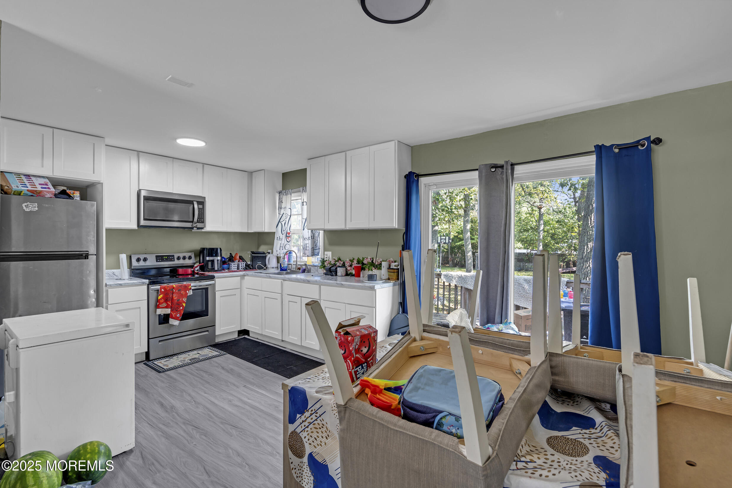 320 Pennsylvania Avenue Pine Beach, NJ 08741 - Photo 9 of 29 a living room with furniture a flat screen tv and a refrigerator