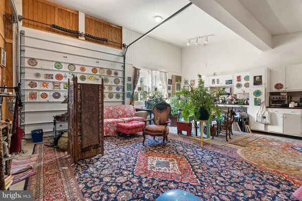 a open kitchen with a refrigerator a stove a sink dishwasher and a dining table with wooden floor