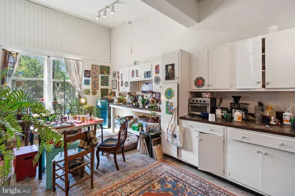 a dining room with a wooden table and chairs