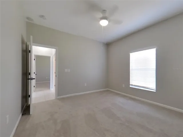 an empty room with windows and closet