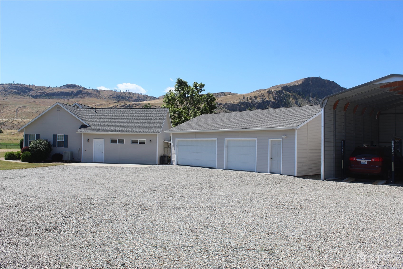 145 Pharr Road Riverside, WA 98849 - Photo 18 of 38 a front view of a house with a yard and mountain view