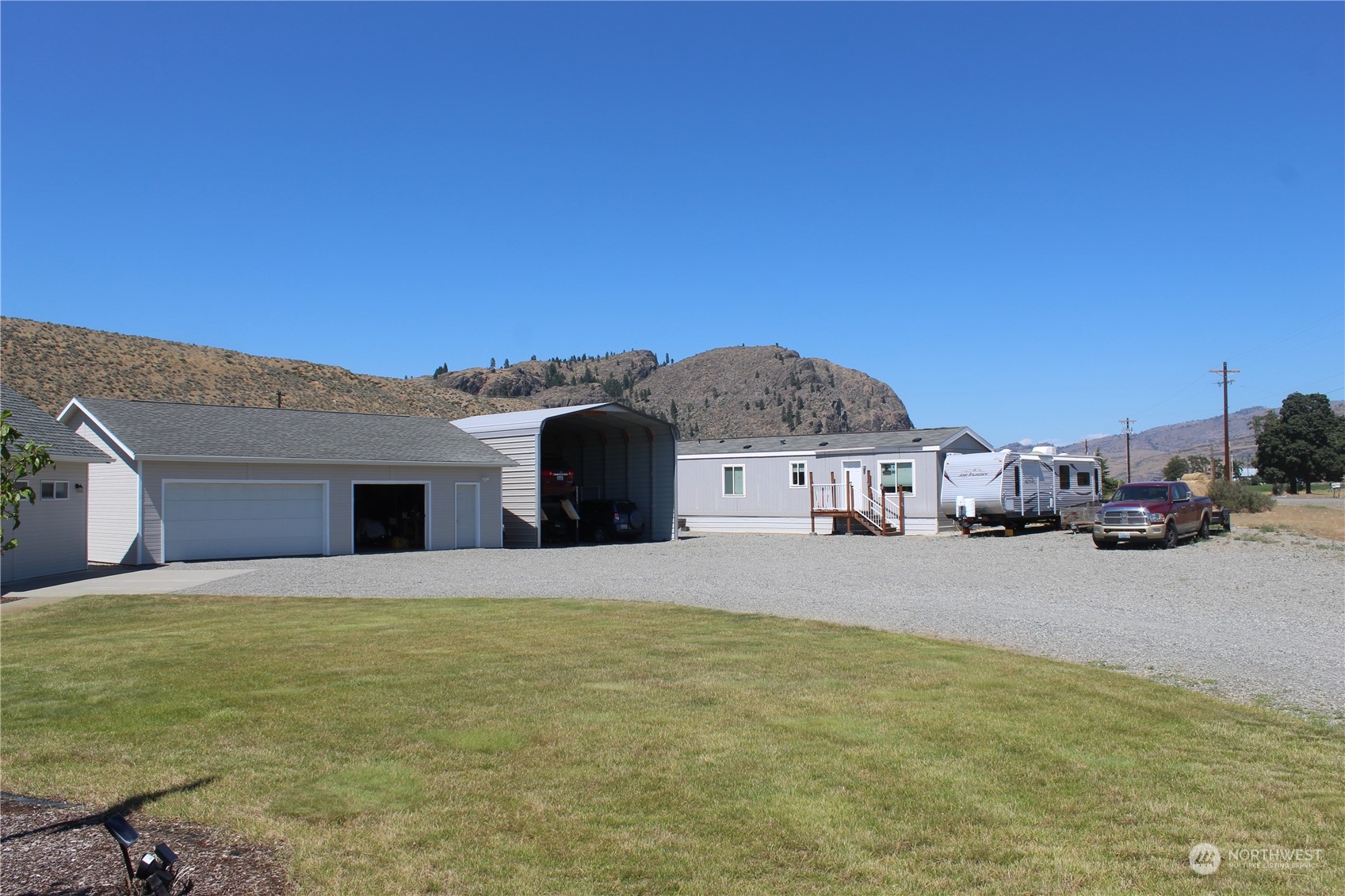 145 Pharr Road Riverside, WA 98849 - Photo 23 of 38 a front view of a house with a yard and garage