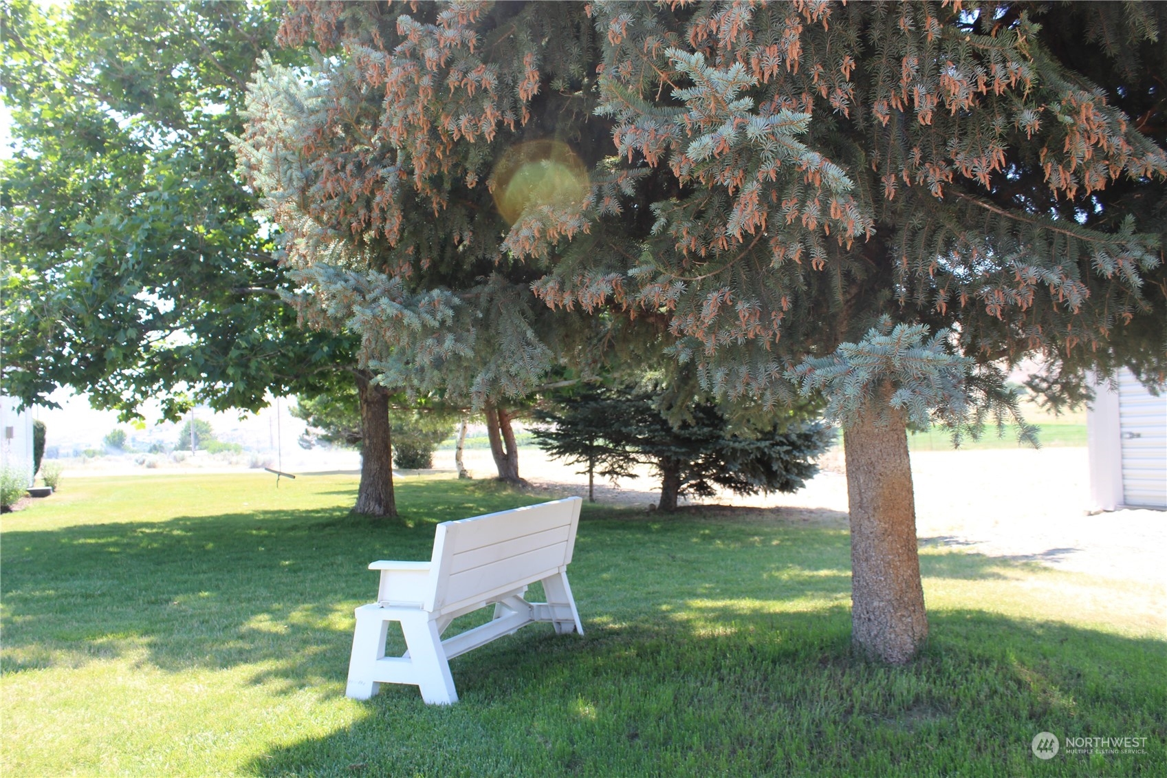 145 Pharr Road Riverside, WA 98849 - Photo 34 of 38 a view of a garden with a bench