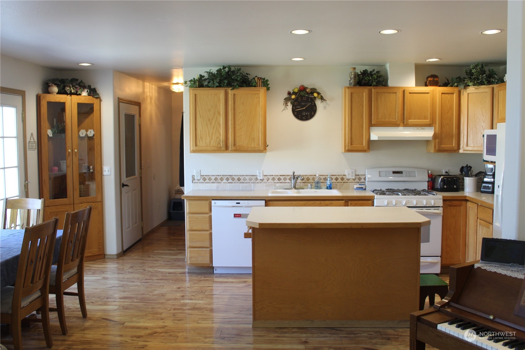 145 Pharr Road Riverside, WA 98849 - Photo 6 of 38 a kitchen with kitchen island stainless steel appliances a sink and a refrigerator
