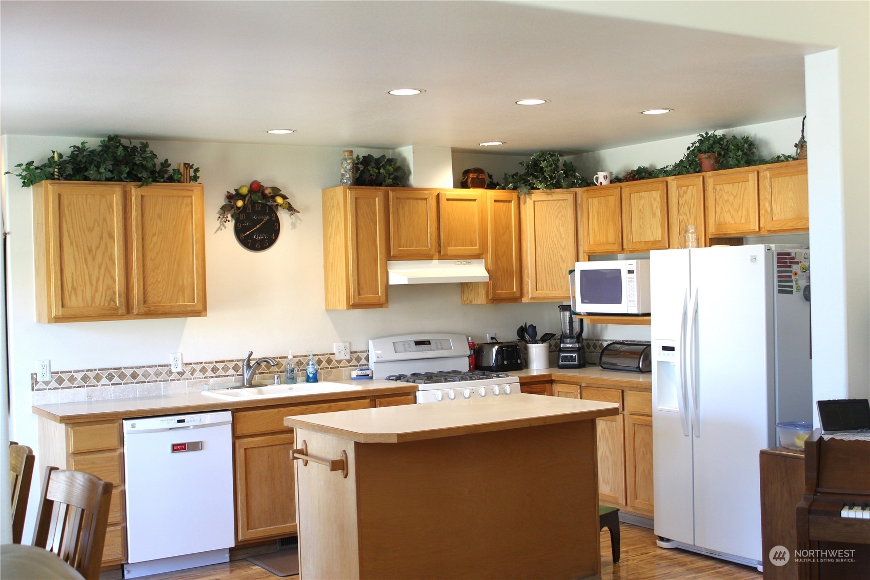145 Pharr Road Riverside, WA 98849 - Photo 8 of 38 a kitchen with a sink a refrigerator and a stove top oven