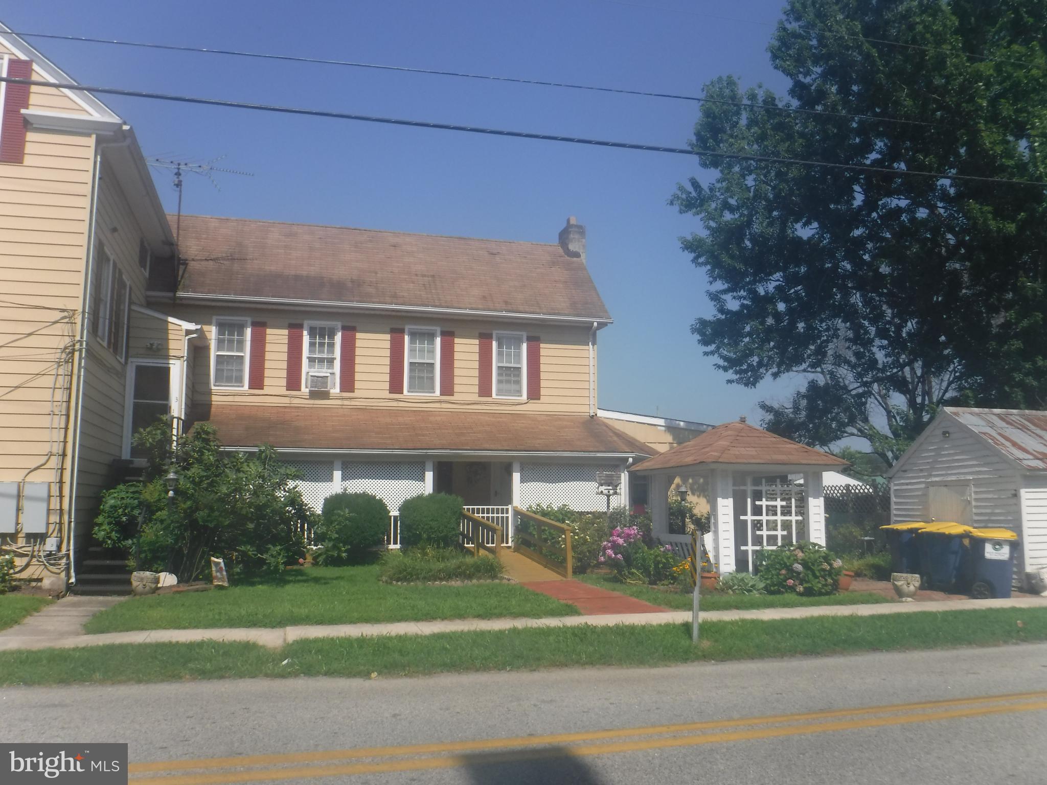 a front view of a building with a garden