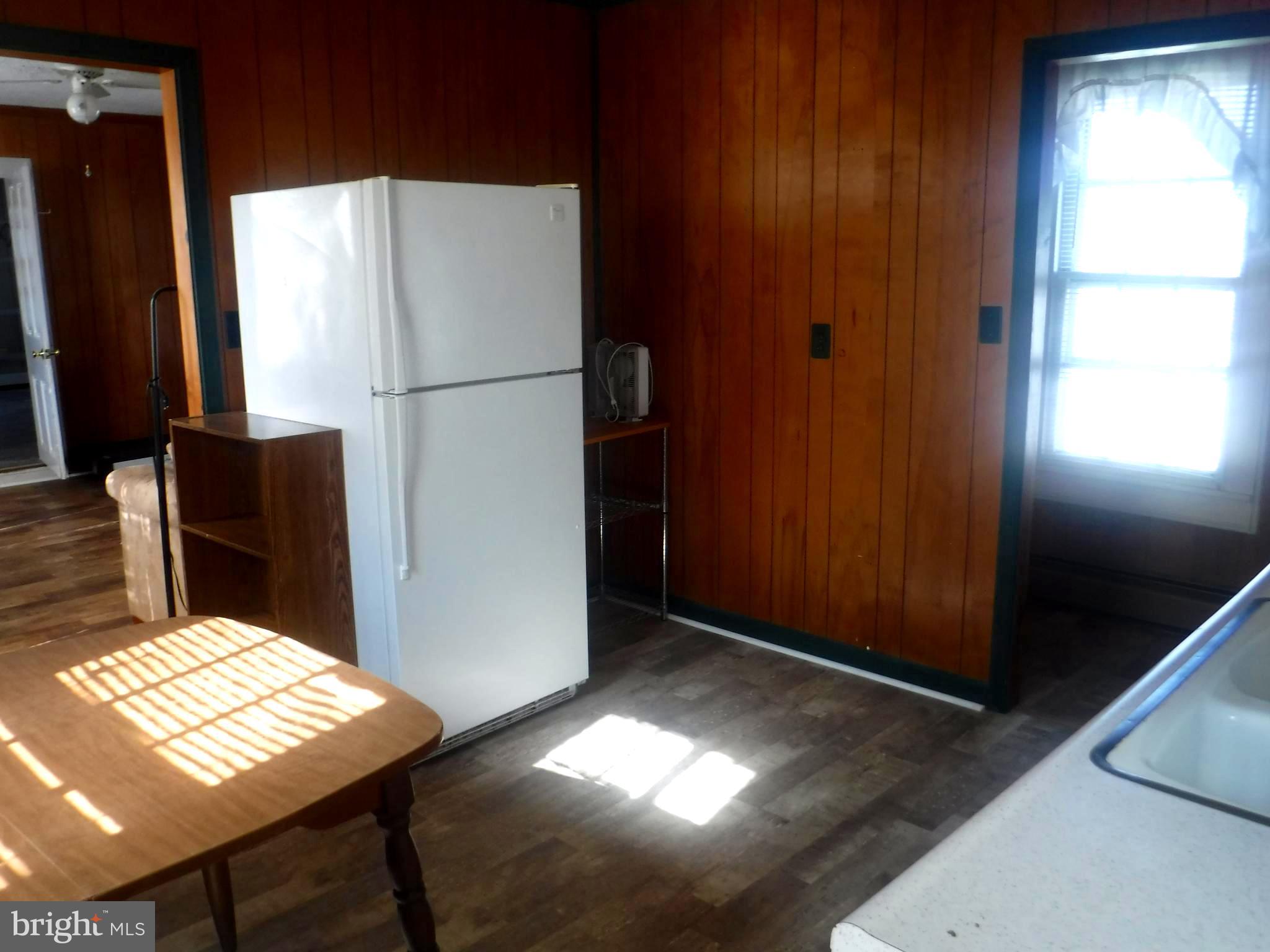 Apt #2-19 Apt, Unit 2 19 Felton, DE 19943 - Photo 3 of 10 a kitchen with refrigerator and table