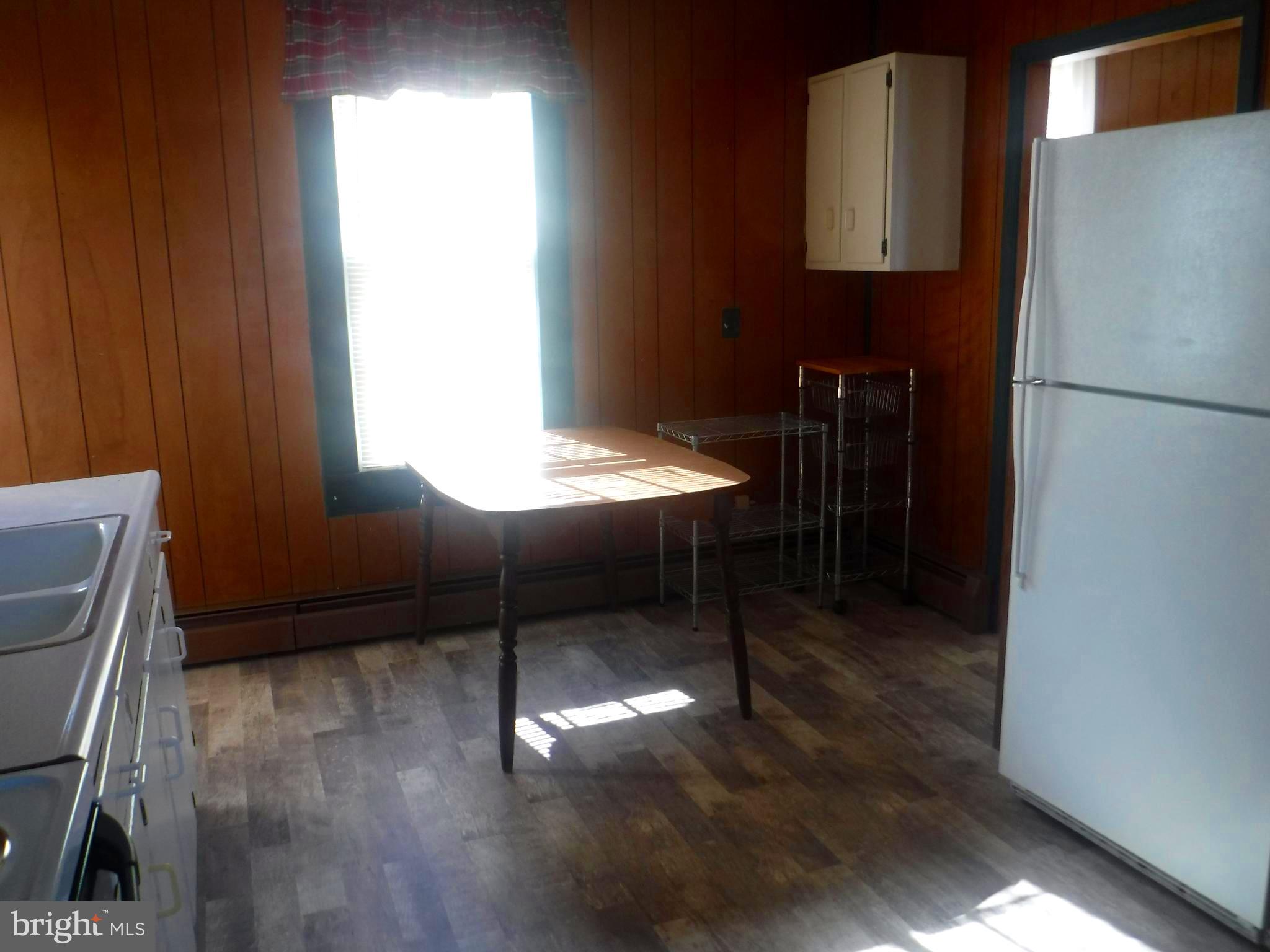 Apt #2-19 Apt, Unit 2 19 Felton, DE 19943 - Photo 4 of 10 a kitchen with a refrigerator and a window