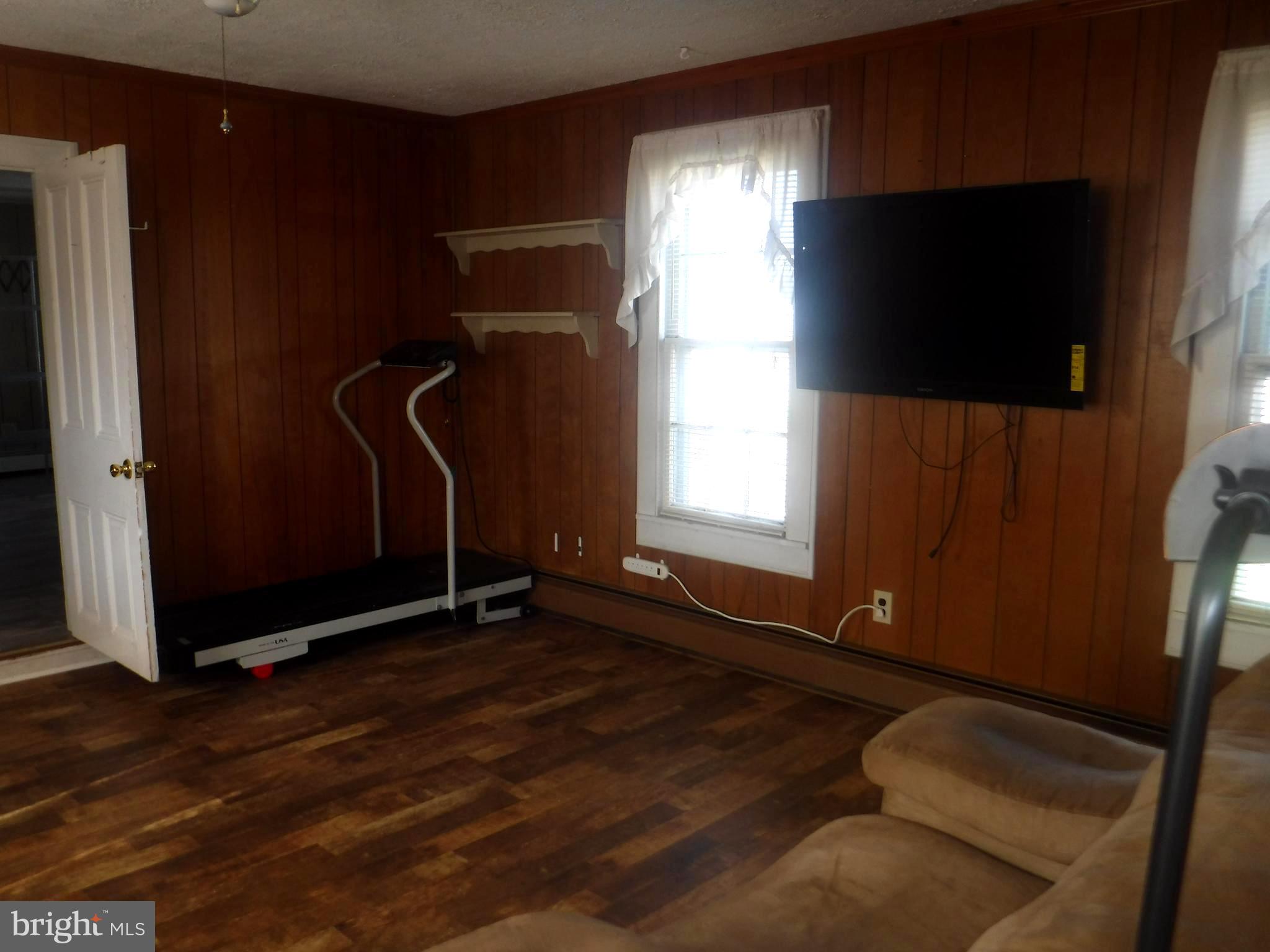 Apt #2-19 Apt, Unit 2 19 Felton, DE 19943 - Photo 6 of 10 a view of an empty room with wooden floor and a window