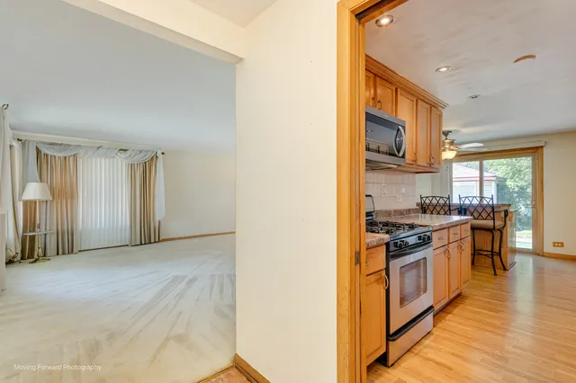 a kitchen with stainless steel appliances granite countertop a stove and a refrigerator