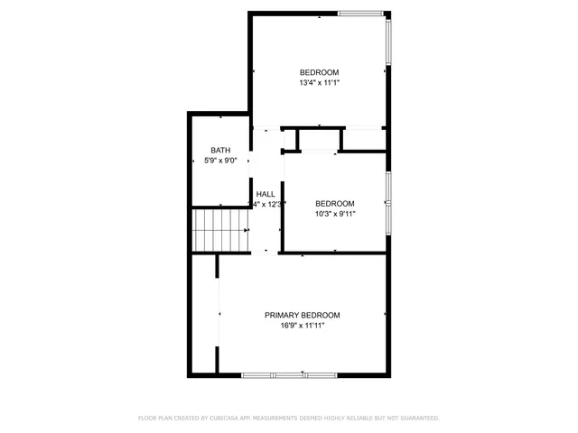 a picture of a bench in front of a wall