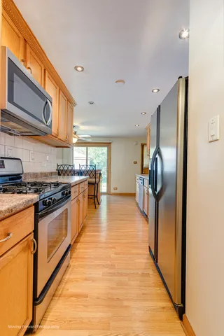 a kitchen with stainless steel appliances granite countertop a stove and a refrigerator
