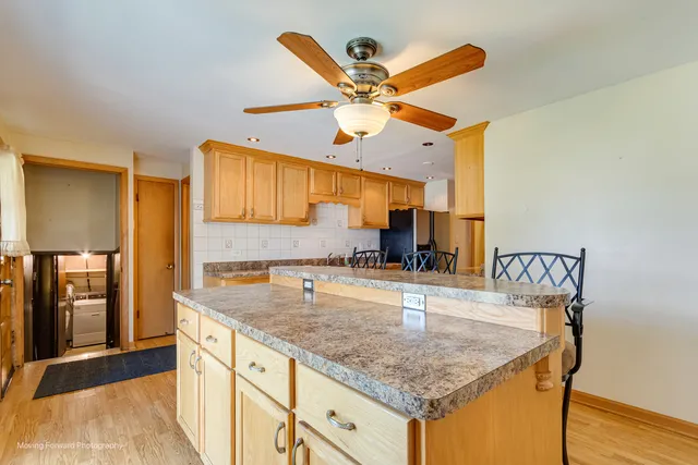 a kitchen with a sink a counter space and stainless steel appliances