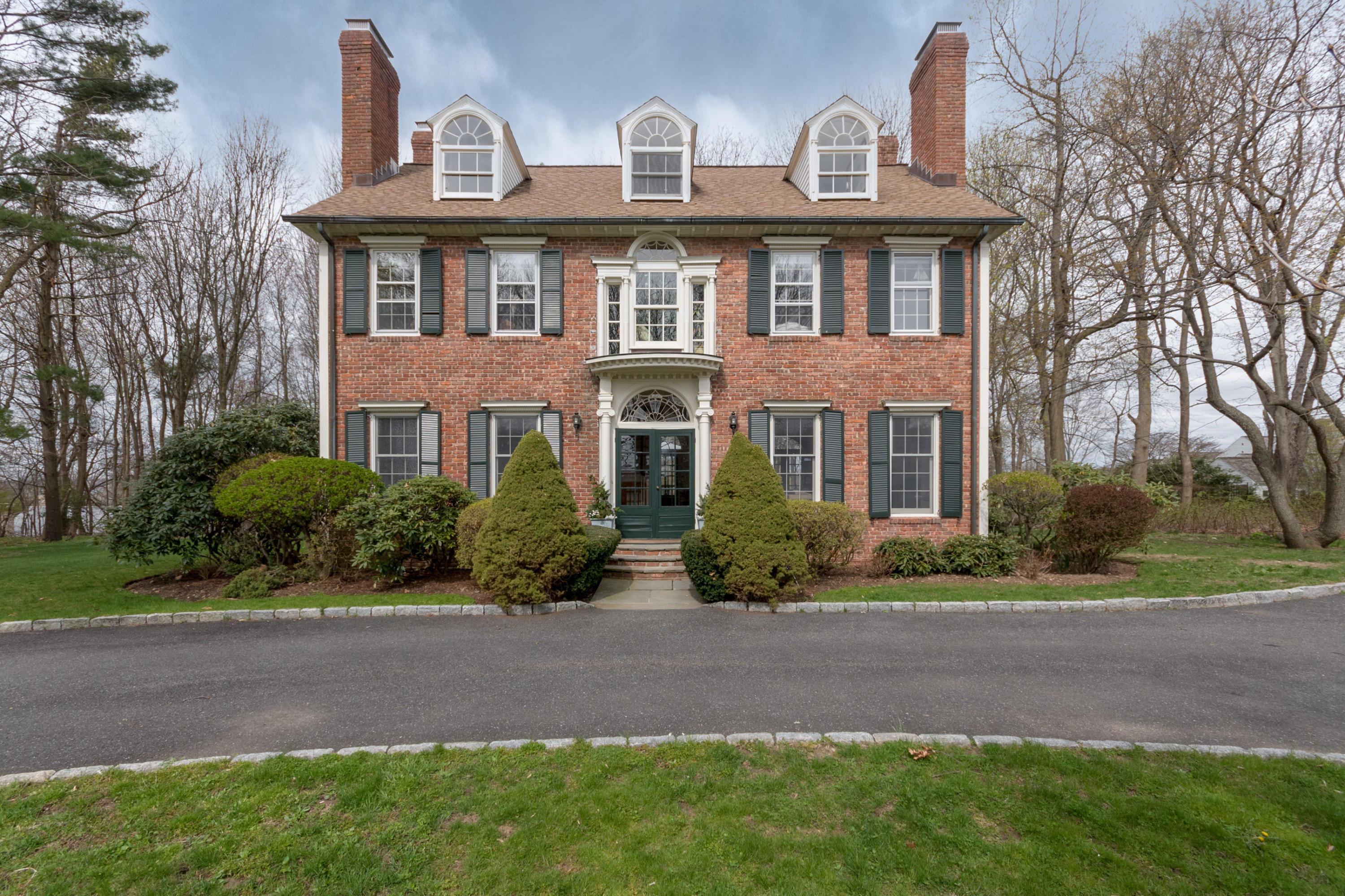 106 Long Neck Point Road Darien, CT 06820 - Photo 1 of 48 a front view of a house with a yard