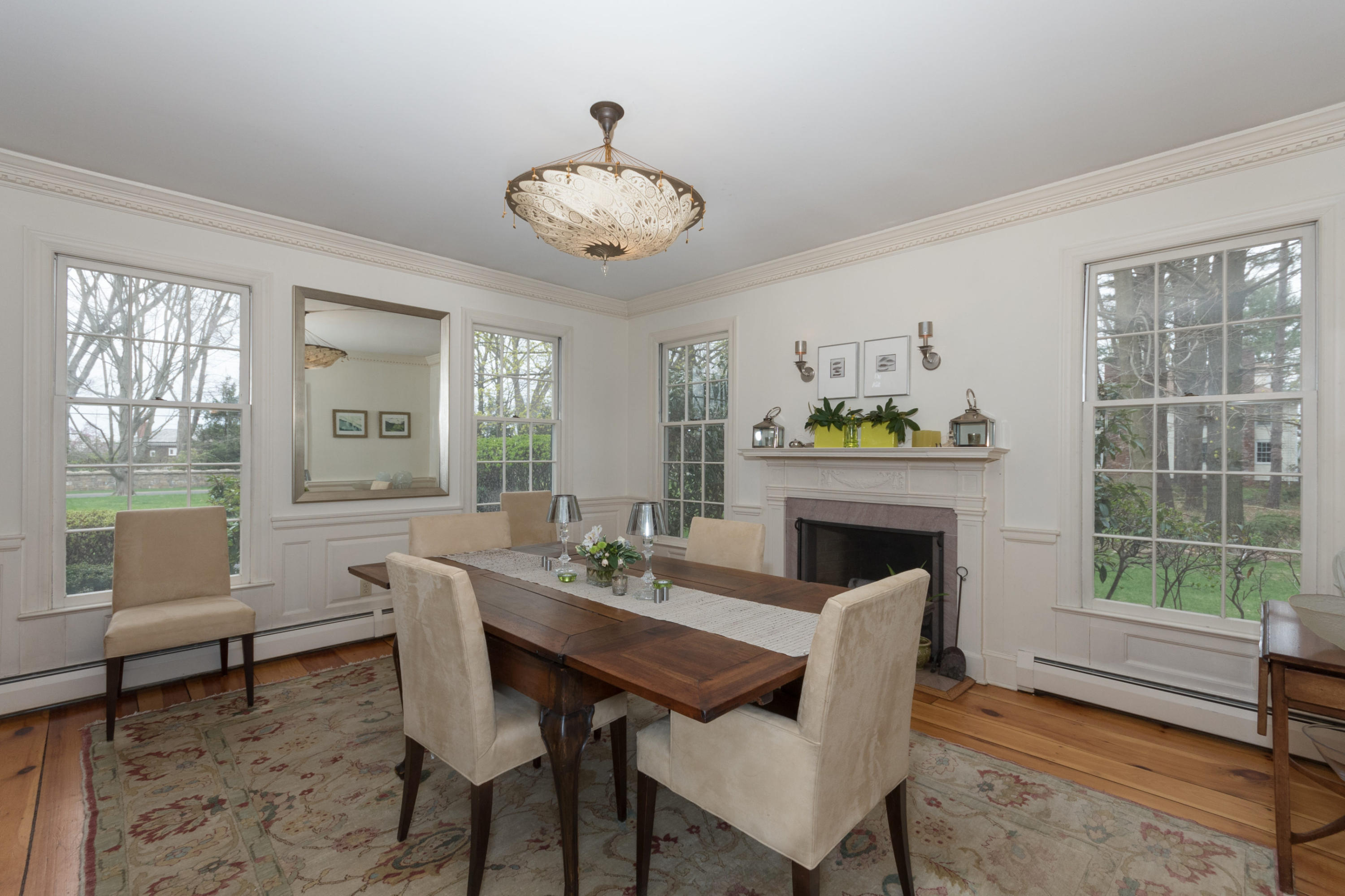 106 Long Neck Point Road Darien, CT 06820 - Photo 14 of 48 a view of a dining room with furniture wooden floor and a chandelier