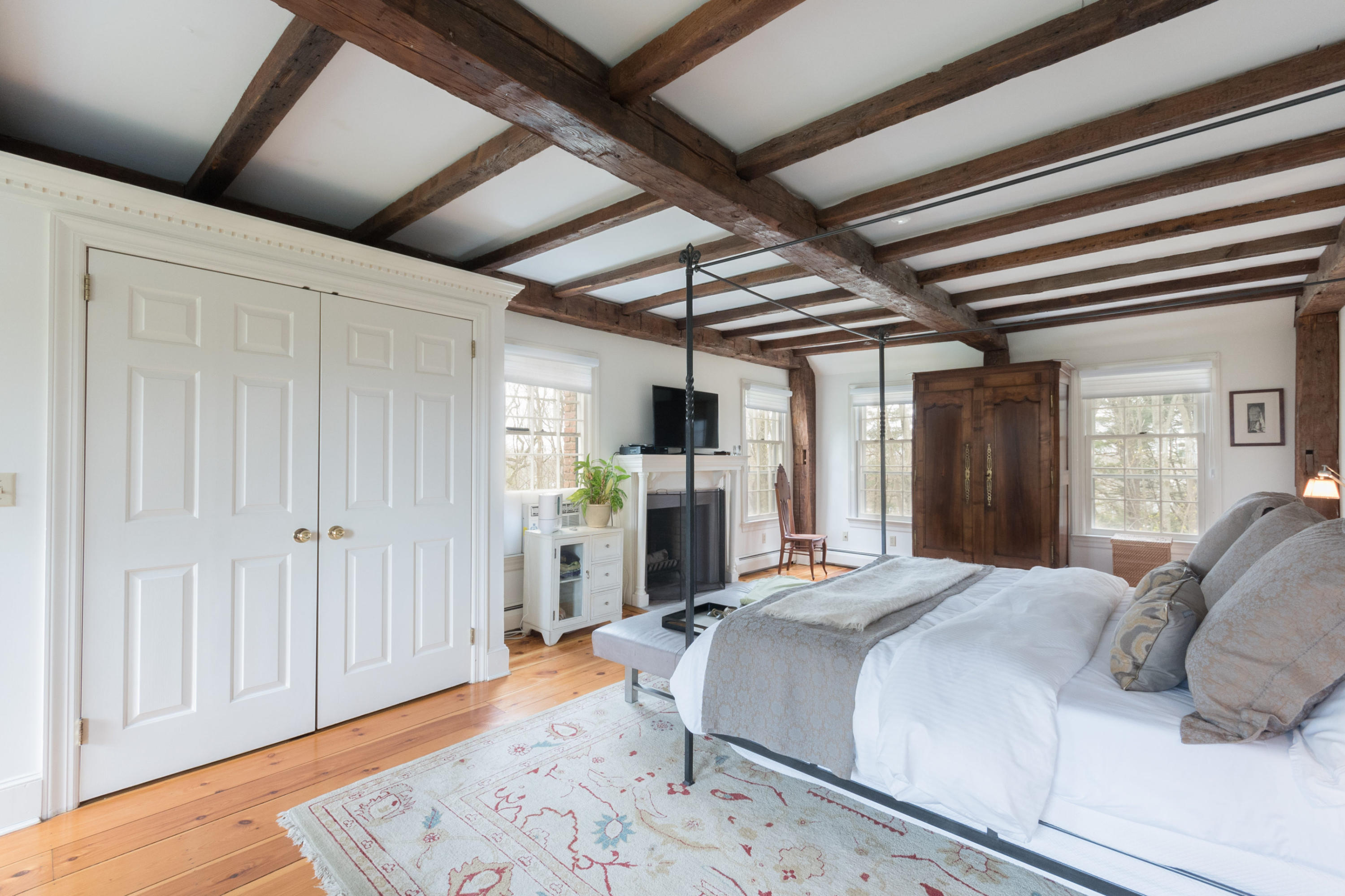 106 Long Neck Point Road Darien, CT 06820 - Photo 24 of 48 a bed room with a bed and a chair