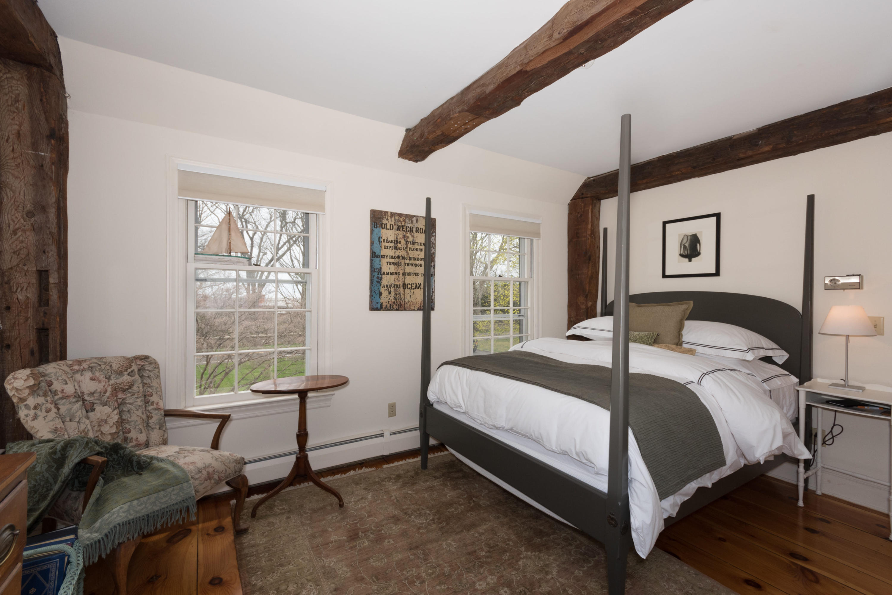 106 Long Neck Point Road Darien, CT 06820 - Photo 30 of 48 a bedroom with a bed and a chair