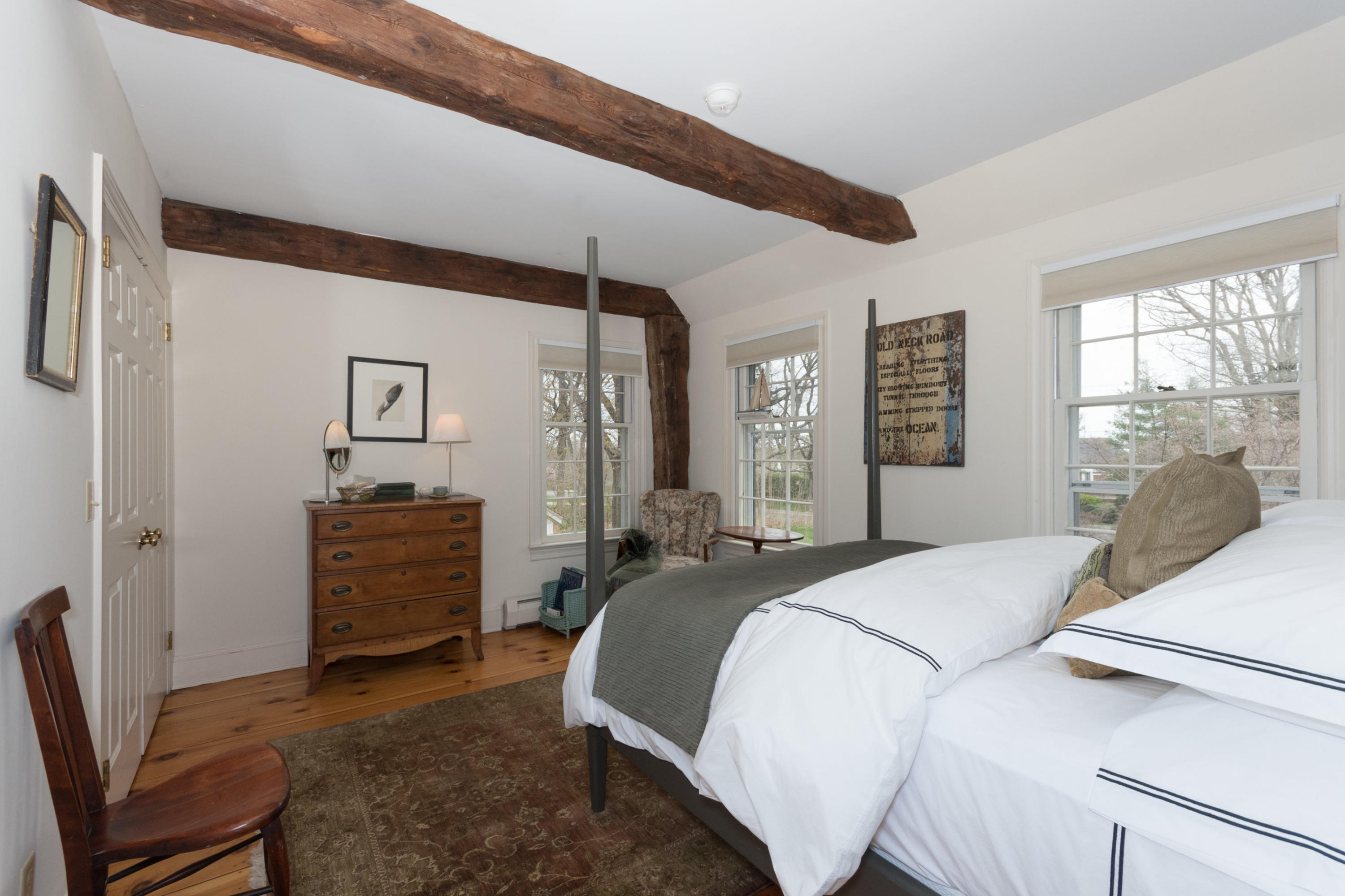106 Long Neck Point Road Darien, CT 06820 - Photo 31 of 48 a bedroom with a bed and large windows