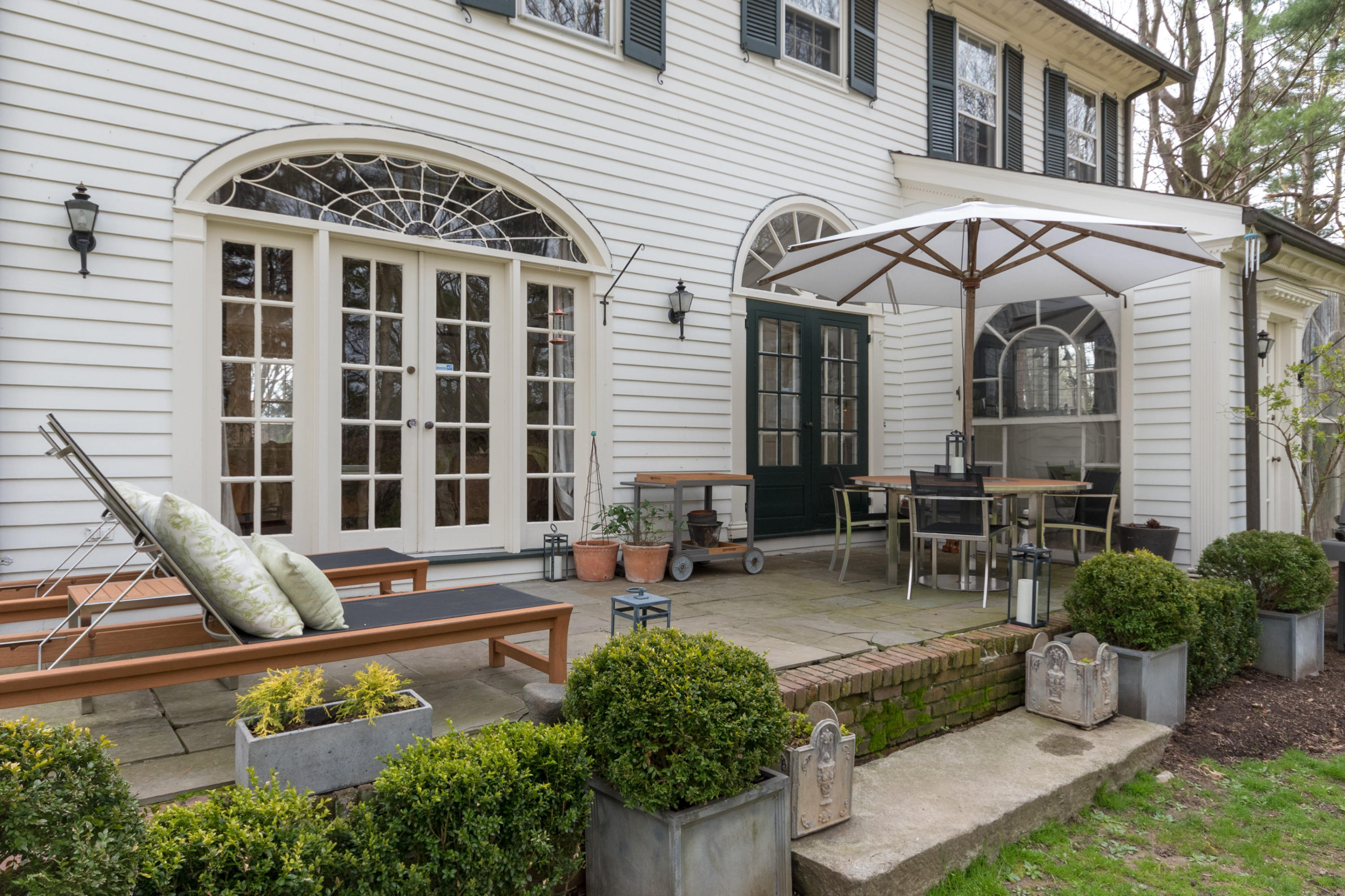106 Long Neck Point Road Darien, CT 06820 - Photo 40 of 48 a view of a chairs and table in the patio
