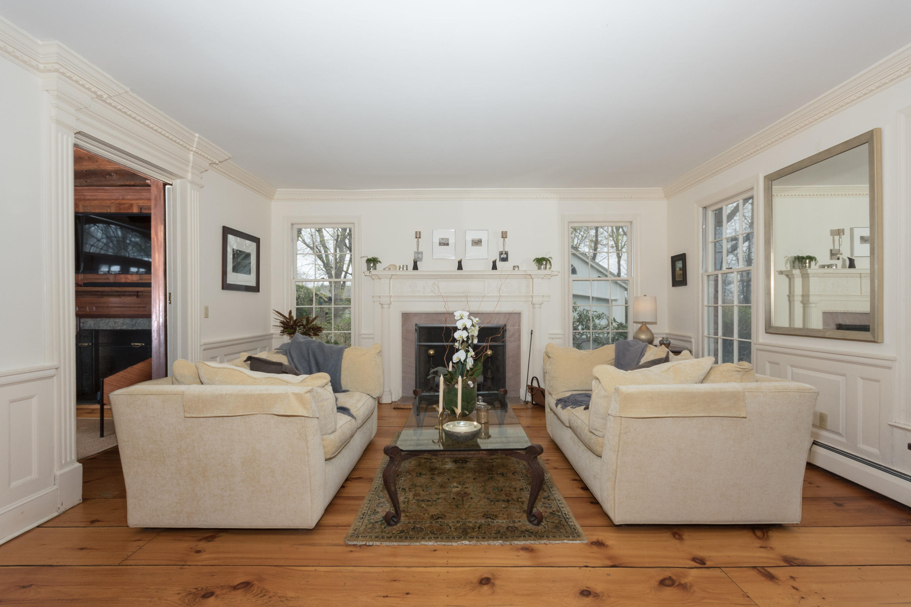 106 Long Neck Point Road Darien, CT 06820 - Photo 10 of 48 a living room with furniture and a fireplace