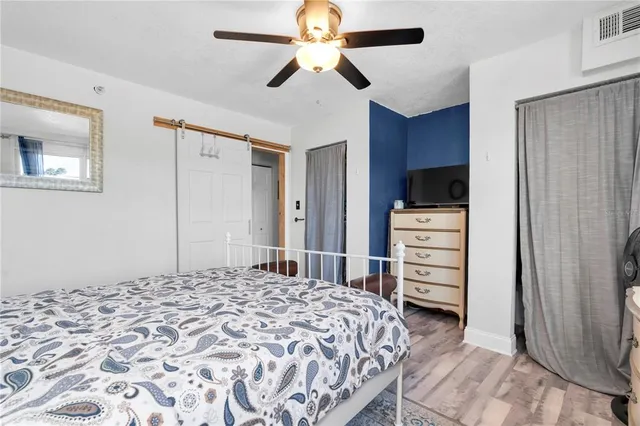 a bedroom with a bed and a television