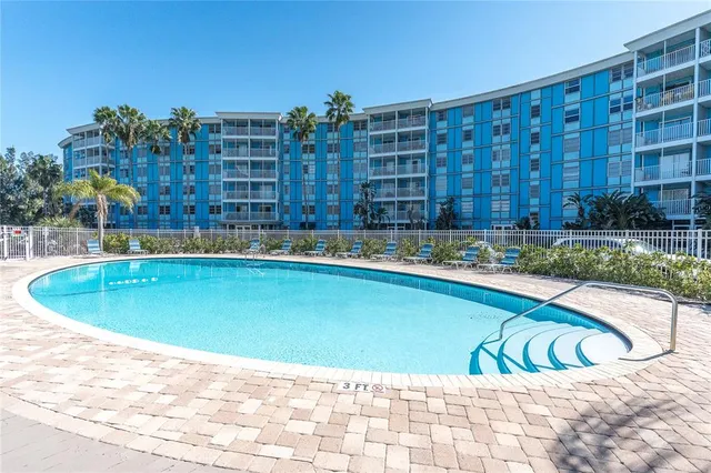 a swimming pool with outdoor seating and yard