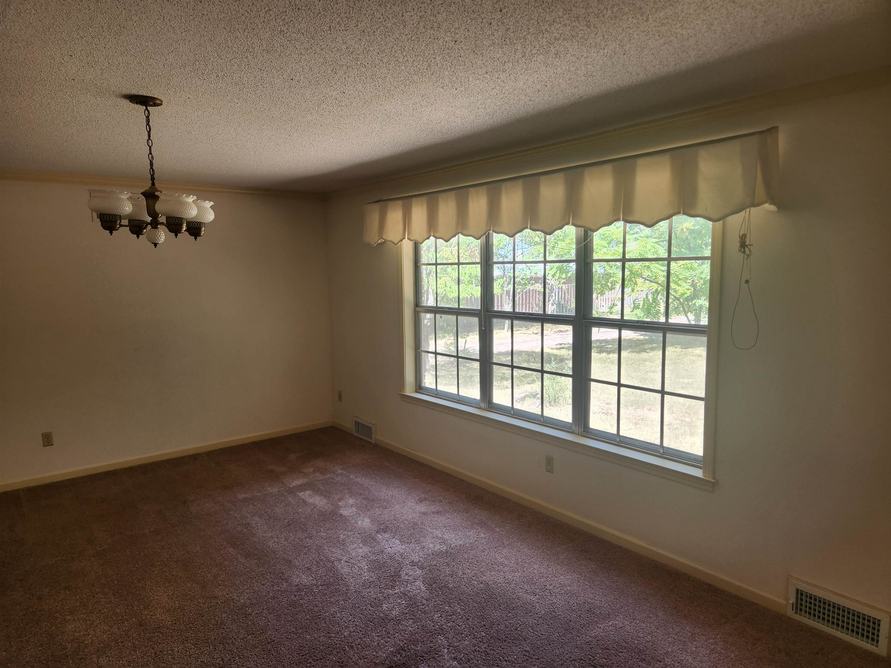 7505 Dexter Road Cordova, TN 38016 - Photo 7 of 27 Living room with carpet floors, a textured ceiling, and a chandelier