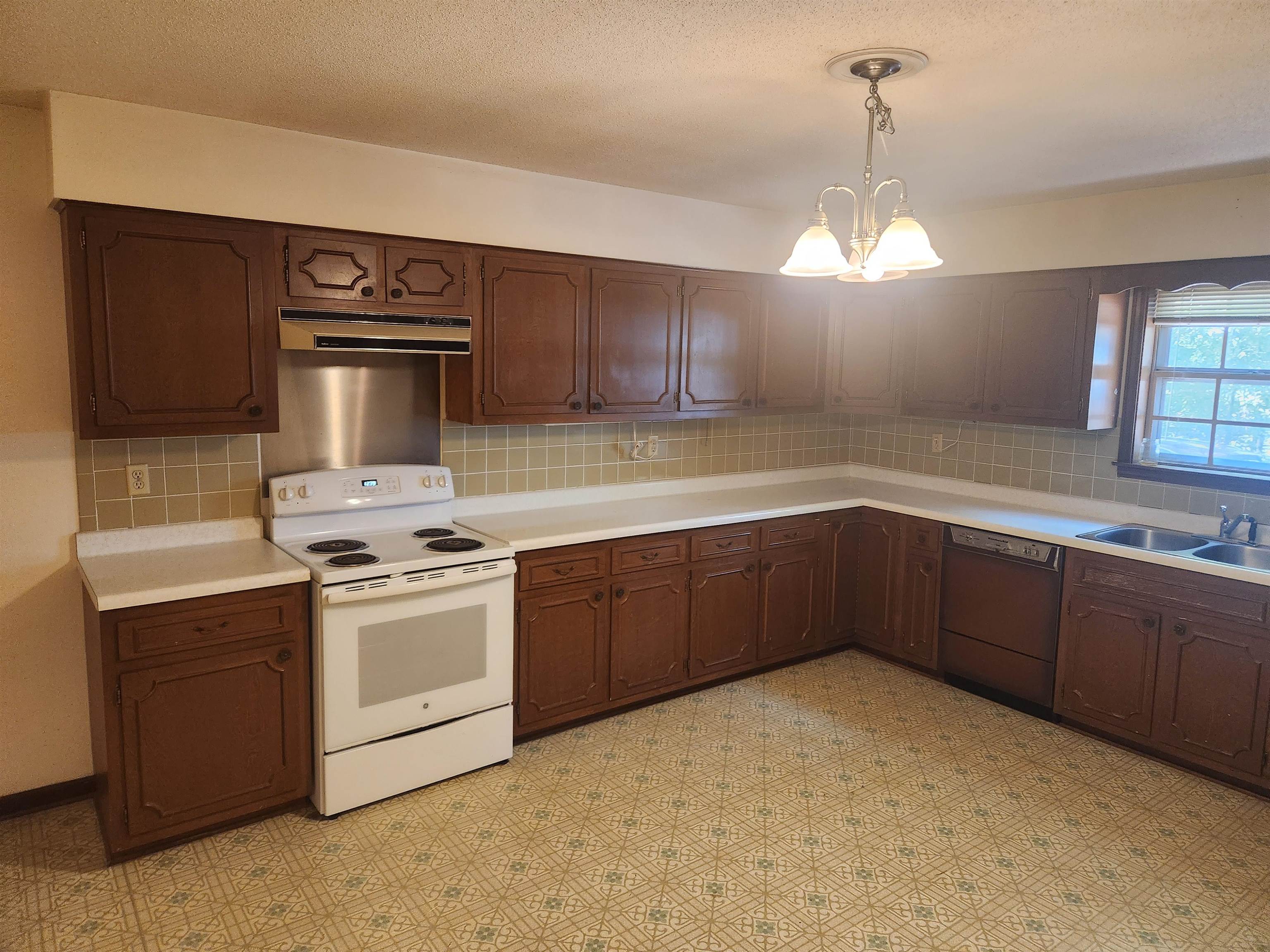 7505 Dexter Road Cordova, TN 38016 - Photo 9 of 27 Kitchen with sink, dishwasher, white electric range, and tasteful backsplash